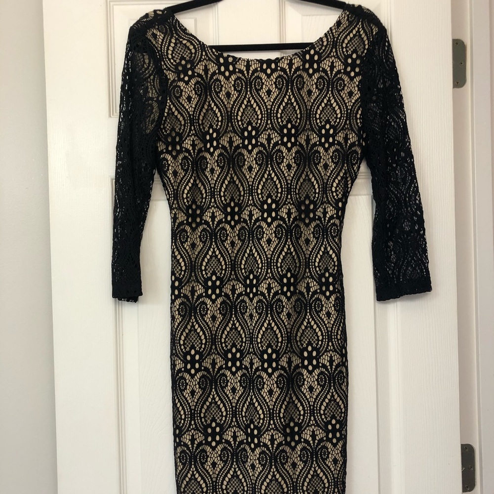 Sheer lace black dress with nude underlay.